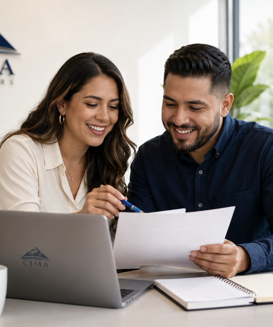 A bilingual CPA reviewing finances with a small-business client.